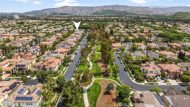 5 Modesto, Irvine, CA 92602 - aerial overview of property's location featuring a mountain backdrop and nearby suburban area