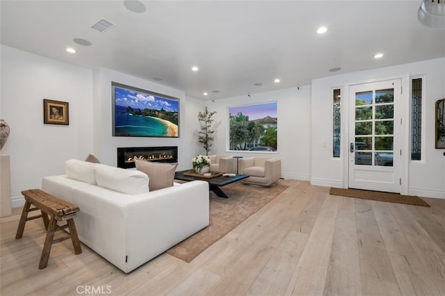 5 Modesto, Irvine, CA 92602 - living area featuring a glass covered fireplace, light wood-style floors, recessed lighting, plenty of natural light, and baseboards