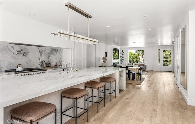 5 Modesto, Irvine, CA 92602 - kitchen with light stone counters, tasteful backsplash, light wood finished floors, range, and recessed lighting