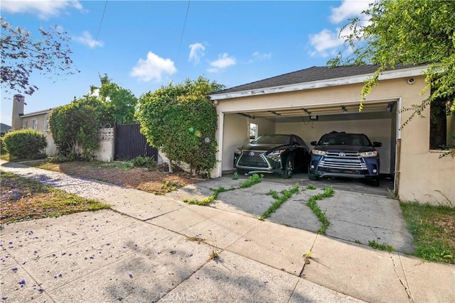 7726 Dalton Ave, Los Angeles, CA 90047 - view of side of property featuring a garage, stucco siding, and driveway