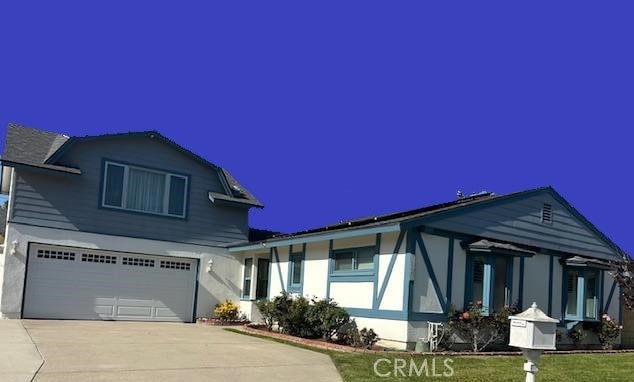 16762 Madrone Cir, Fountain Valley, CA 92708 - view of front of home with an attached garage, concrete driveway, and stucco siding