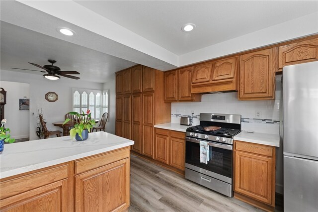16762 Madrone Cir, Fountain Valley, CA 92708 - kitchen featuring stainless steel appliances, light countertops, decorative backsplash, brown cabinets, and recessed lighting