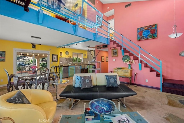 801 Box Canyon Rd, Canoga Park, CA 91304 - living room featuring baseboards, a high ceiling, and stairs
