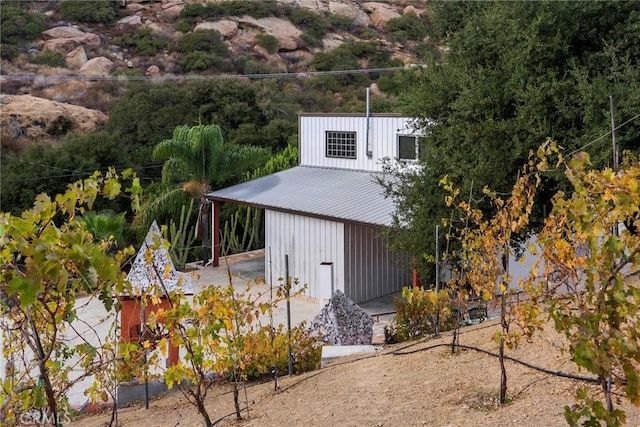 801 Box Canyon Rd, Canoga Park, CA 91304 - view of property exterior featuring board and batten siding, metal roof, and an outdoor structure