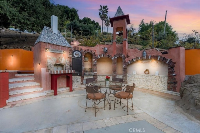 801 Box Canyon Rd, Canoga Park, CA 91304 - patio terrace at dusk with a patio area and outdoor dining space