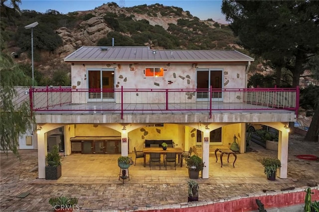 801 Box Canyon Rd, Canoga Park, CA 91304 - back of house with a patio area, stucco siding, a mountain view, and metal roof