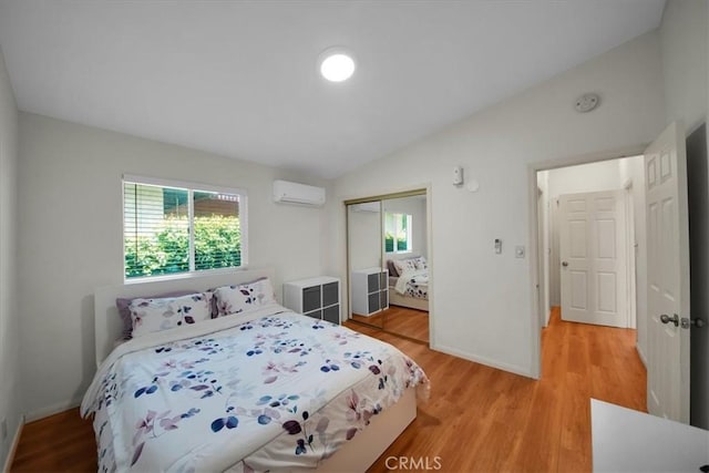 15510 Midcrest Dr, Whittier, CA 90604 - bedroom featuring vaulted ceiling, a closet, a wall mounted air conditioner, light wood-style floors, and baseboards