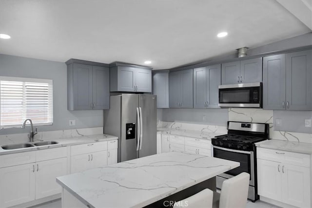 15510 Midcrest Dr, Whittier, CA 90604 - kitchen with appliances with stainless steel finishes, a sink, light stone countertops, a kitchen island, and recessed lighting