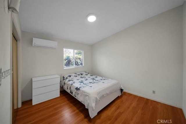 15510 Midcrest Dr, Whittier, CA 90604 - bedroom with a wall mounted air conditioner, wood finished floors, baseboards, and a closet