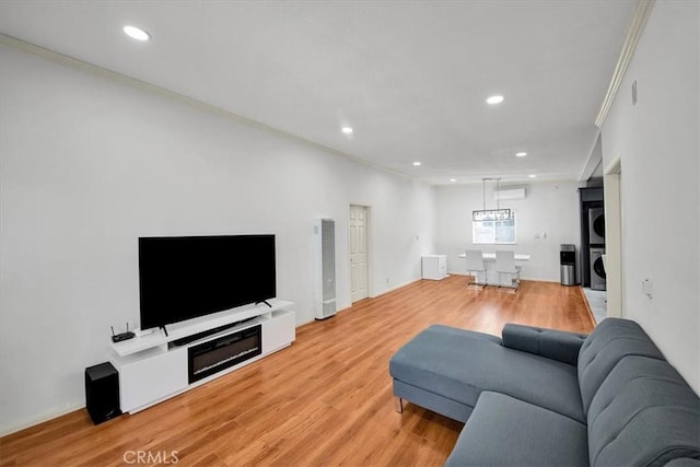 15510 Midcrest Dr, Whittier, CA 90604 - living room featuring stacked washer and clothes dryer, crown molding, a heating unit, recessed lighting, and light wood-type flooring