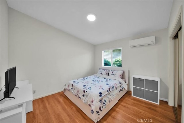 15510 Midcrest Dr, Whittier, CA 90604 - bedroom with a wall mounted AC, wood finished floors, and baseboards