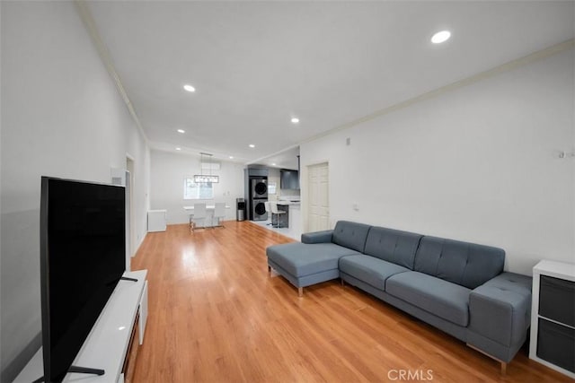 15510 Midcrest Dr, Whittier, CA 90604 - living area with stacked washer / dryer, crown molding, light wood-style floors, and recessed lighting