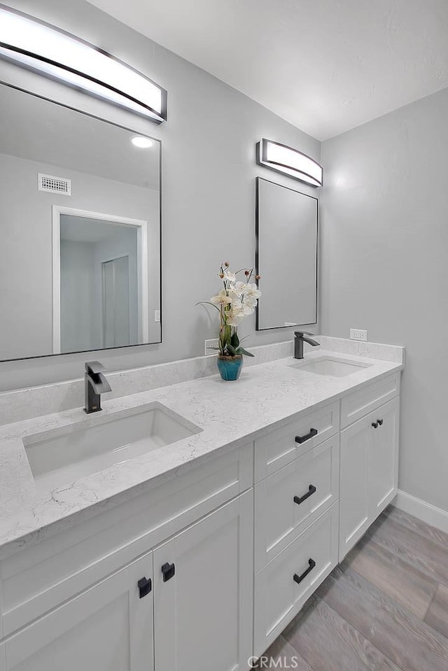 7747 Onyx Ave, Rancho Cucamonga, CA 91730 - full bathroom featuring double vanity and wood finished floors