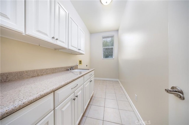 2122 Meteora Way, Rowland Heights, CA 91748 - washroom with washer hookup, cabinet space, light tile patterned flooring, and baseboards