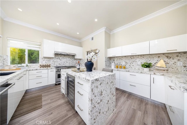 2122 Meteora Way, Rowland Heights, CA 91748 - kitchen with stainless steel appliances, ornamental molding, wine cooler, backsplash, and white cabinetry