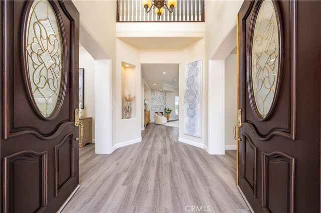 2122 Meteora Way, Rowland Heights, CA 91748 - foyer with light wood finished floors, arched walkways, baseboards, and a chandelier