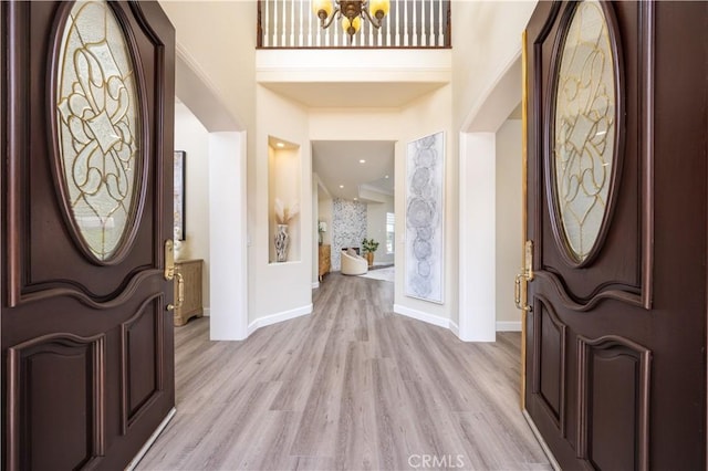 2122 Meteora Way, Rowland Heights, CA 91748 - foyer entrance featuring light wood finished floors, arched walkways, and a chandelier