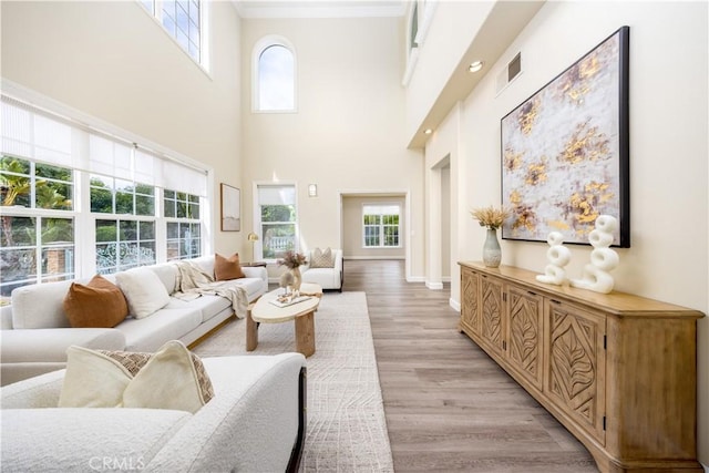 2122 Meteora Way, Rowland Heights, CA 91748 - living room with light wood-type flooring, crown molding, a towering ceiling, and baseboards