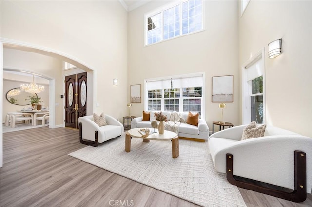 2122 Meteora Way, Rowland Heights, CA 91748 - living room with a chandelier, plenty of natural light, a towering ceiling, wood finished floors, and arched walkways