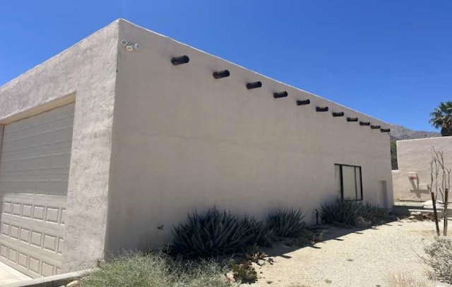 2207 Hoberg Rd, Borrego Springs, CA 92004 - view of side of property featuring a garage and stucco siding