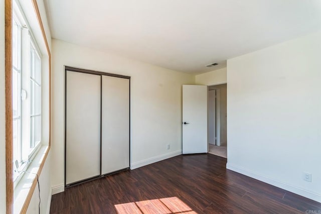 39787 Castile Ave, Murrieta, CA 92562 - unfurnished bedroom with dark wood-style floors, multiple windows, and a closet