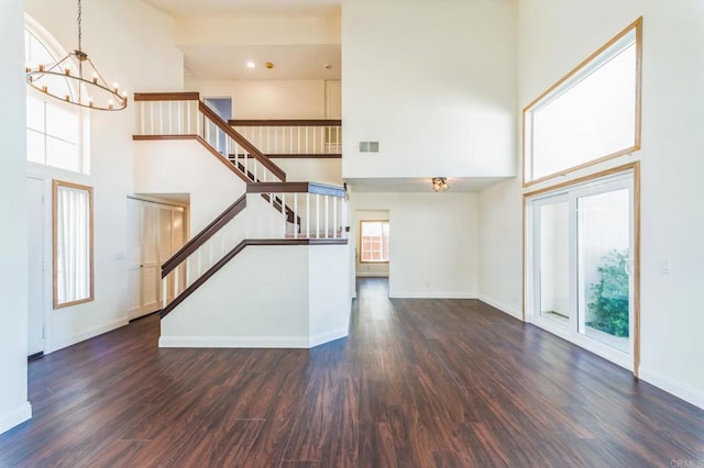 39787 Castile Ave, Murrieta, CA 92562 - unfurnished living room featuring a high ceiling, stairway, a chandelier, and wood finished floors