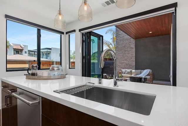 731 Valley Ave, Solana Beach, CA 92075 - kitchen featuring light countertops, pendant lighting, dark brown cabinets, and dishwasher