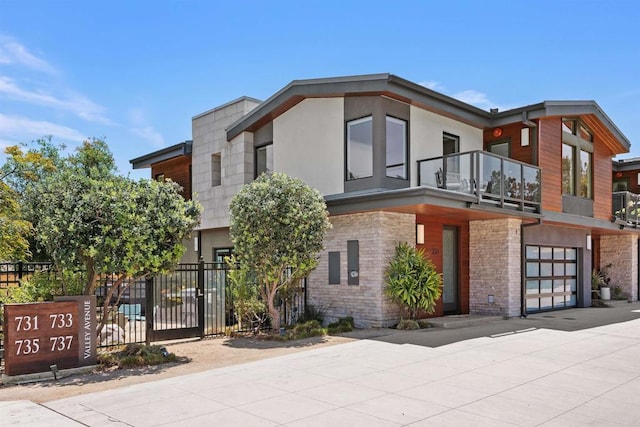 731 Valley Ave, Solana Beach, CA 92075 - modern home featuring a balcony, concrete driveway, an attached garage, and stucco siding