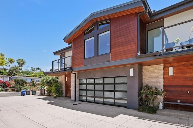 731 Valley Ave, Solana Beach, CA 92075 - view of side of property with a garage, a balcony, and stone siding