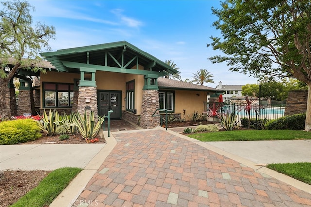 1263 Date Palm Dr, Carson, CA 90746 - view of front of house featuring stucco siding, stone siding, and covered porch