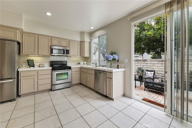 1263 Date Palm Dr, Carson, CA 90746 - kitchen with stainless steel appliances, light countertops, light tile patterned floors, recessed lighting, and a sink