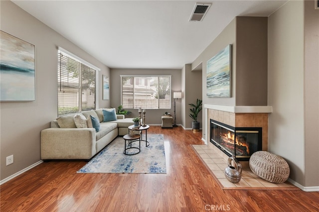 1263 Date Palm Dr, Carson, CA 90746 - living room featuring a tile fireplace, wood finished floors, and baseboards