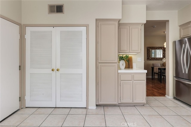1263 Date Palm Dr, Carson, CA 90746 - kitchen featuring freestanding refrigerator, cream cabinetry, light tile patterned flooring, and baseboards
