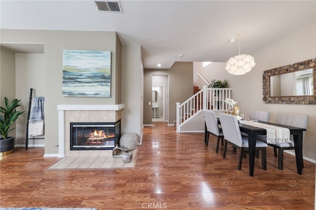 1263 Date Palm Dr, Carson, CA 90746 - dining space featuring stairs, wood finished floors, baseboards, and a tile fireplace