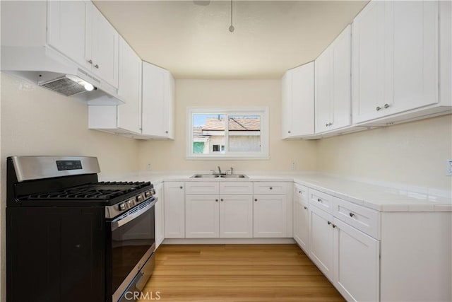 451 N Indiana St, Los Angeles, CA 90063 - kitchen featuring gas stove, a sink, light countertops, white cabinets, and light wood finished floors