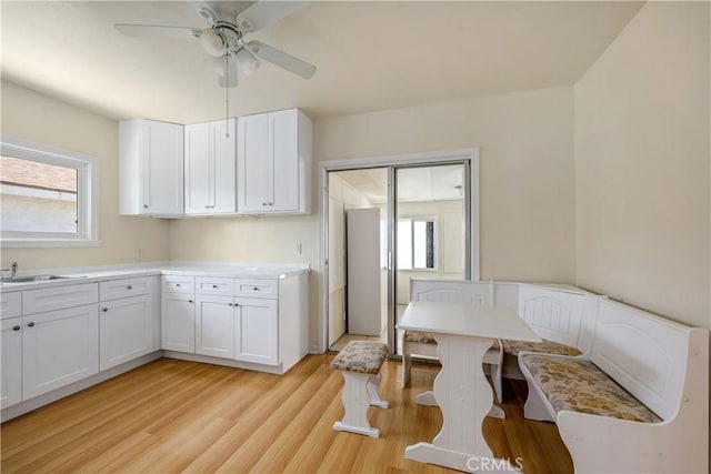 451 N Indiana St, Los Angeles, CA 90063 - kitchen featuring plenty of natural light, white cabinets, a ceiling fan, and light wood-type flooring
