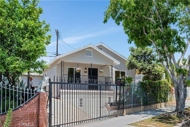451 N Indiana St, Los Angeles, CA 90063 - view of front of home with a fenced front yard, stucco siding, and a gate