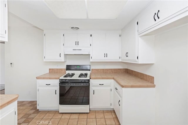 7879 Camino Predera, Rancho Cucamonga, CA 91730 - kitchen with white gas range, premium range hood, white cabinets, and tile counters