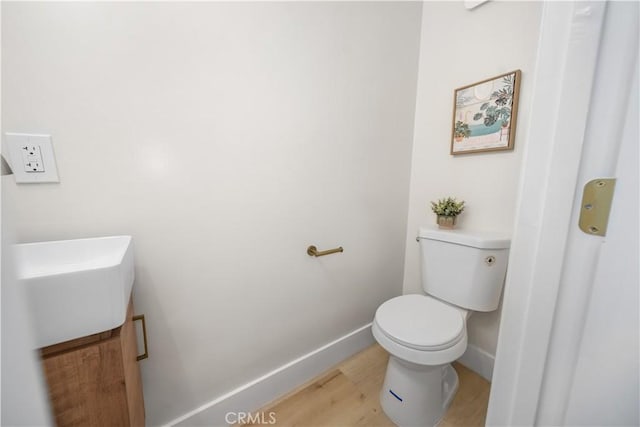 5882 Bowcroft St Unit 2, Los Angeles, CA 90016 - bathroom with toilet, wood finished floors, baseboards, and vanity