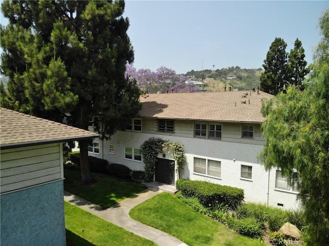5882 Bowcroft St Unit 2, Los Angeles, CA 90016 - view of front of property featuring stucco siding, a front yard, and roof with shingles