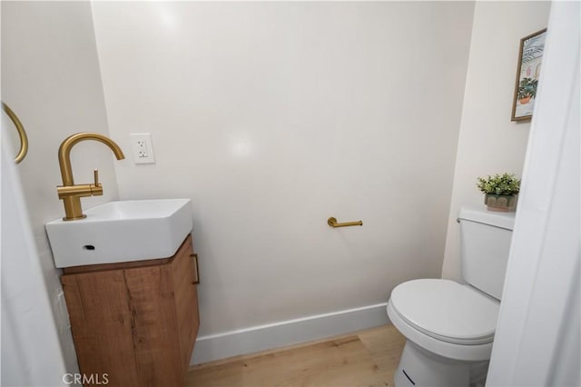 5882 Bowcroft St Unit 2, Los Angeles, CA 90016 - half bathroom with vanity, toilet, wood finished floors, and baseboards