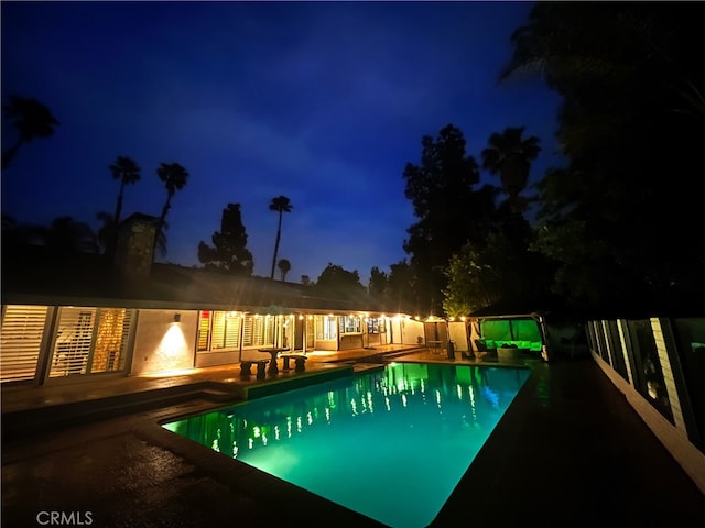 2110 Hathaway Pl, Riverside, CA 92506 - pool at night featuring a patio and an outdoor pool