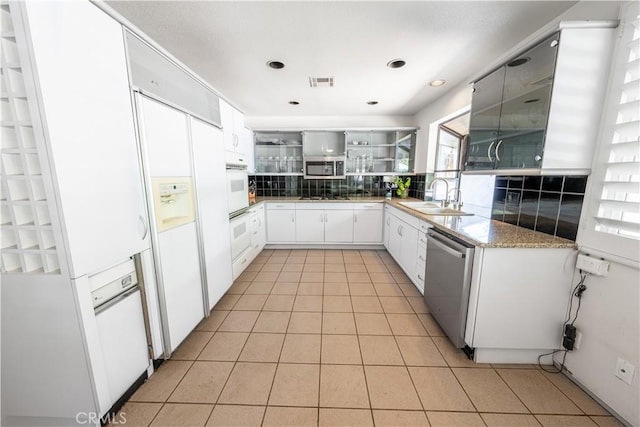 2110 Hathaway Pl, Riverside, CA 92506 - kitchen featuring appliances with stainless steel finishes, a sink, light tile patterned flooring, tasteful backsplash, and white cabinets