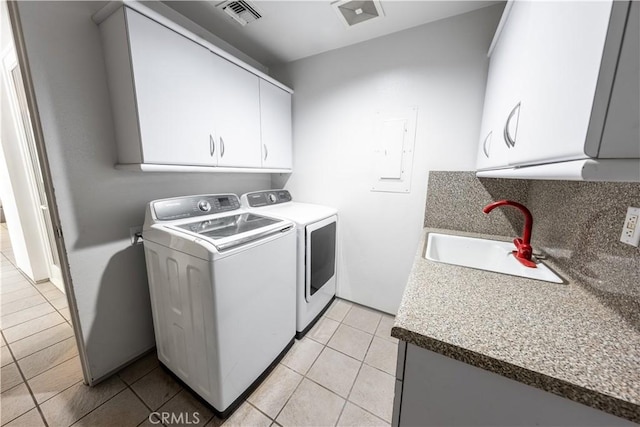 2110 Hathaway Pl, Riverside, CA 92506 - laundry area with cabinet space, washing machine and dryer, and light tile patterned floors