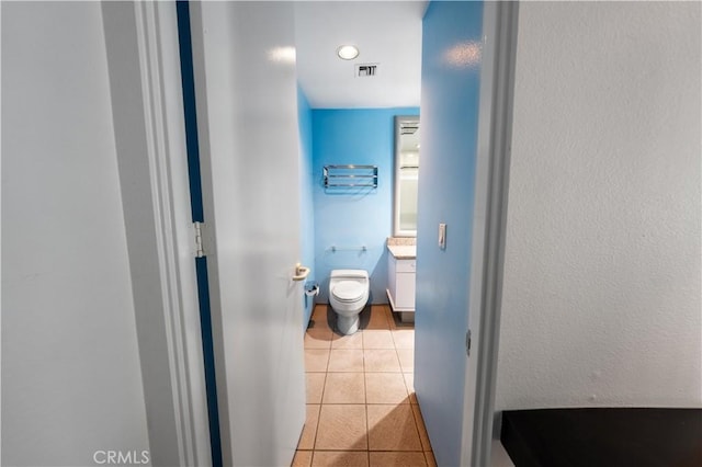 2110 Hathaway Pl, Riverside, CA 92506 - half bathroom featuring vanity, toilet, and tile patterned floors