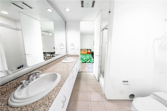 2110 Hathaway Pl, Riverside, CA 92506 - full bathroom featuring tile patterned flooring, a shower with shower door, double vanity, toilet, and recessed lighting
