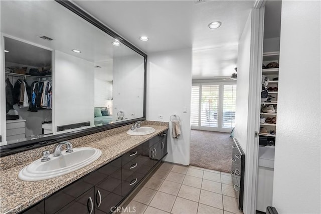 2110 Hathaway Pl, Riverside, CA 92506 - bathroom featuring tile patterned floors, double vanity, a spacious closet, a ceiling fan, and recessed lighting