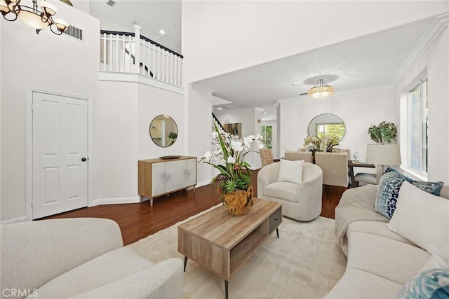 3612 Skylark Way, Brea, CA 92823 - living area with wood finished floors, a chandelier, crown molding, and stairs