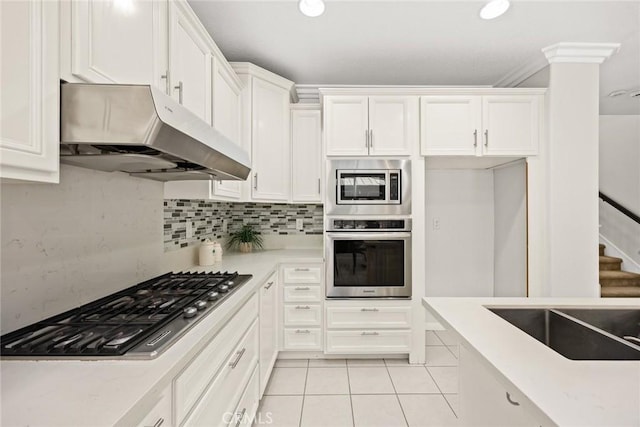 3612 Skylark Way, Brea, CA 92823 - kitchen with appliances with stainless steel finishes, ventilation hood, white cabinetry, light tile patterned floors, and light countertops
