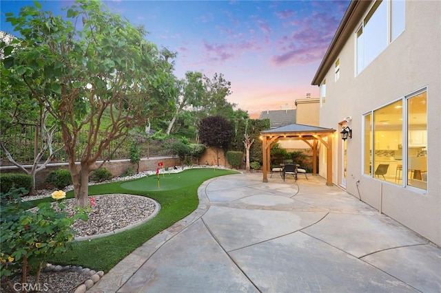3612 Skylark Way, Brea, CA 92823 - patio terrace at dusk with a putting green, a patio area, and a gazebo